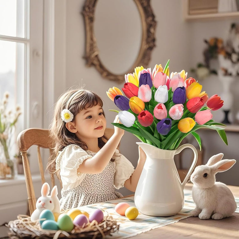 Child with colorful tulips in a vase, Easter eggs, and bunnies on a table.