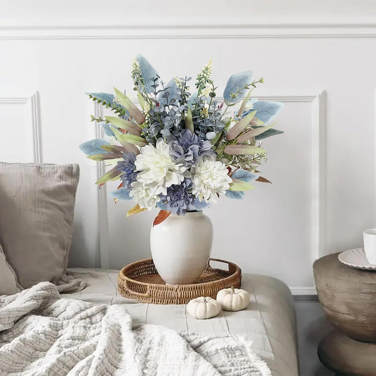 Floral arrangement in a white vase on a coffee table with a neutral background