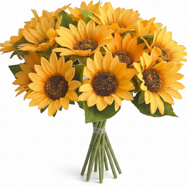 A bouquet of artificial yellow sunflowers with green leaves and stems, tied together with a clear band, on a white background.