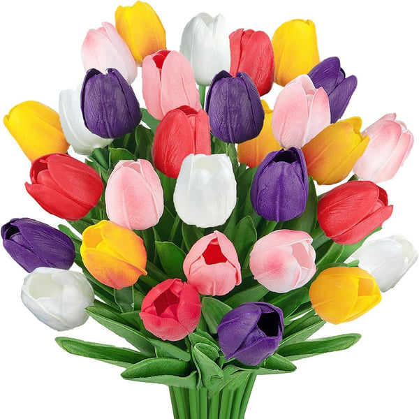 A vibrant bouquet of artificial tulips in multiple colors including yellow, red, pink, white, and purple, with green stems and leaves, isolated on a white background.
