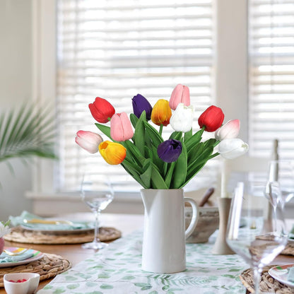 Colorful tulips in a white vase on a table with a blurred background